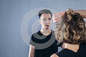 Two female fighter of martial arts practice in gym. Taekwondo coach and student in personal training. Self-defense class for women