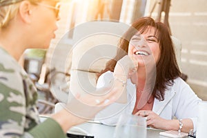 Two Female Friends Enjoying Conversation Outside