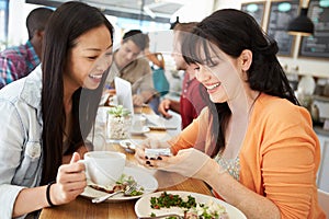 Two Female Friends Friends Meeting For Lunch In Coffee Shop