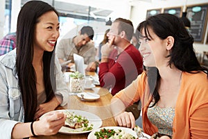 Two Female Friends Friends Meeting For Lunch In Coffee Shop