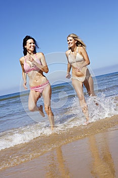 Two Female Friends Having Fun On Beach Holiday Together