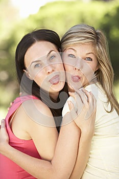 Two Female Friends Pulling Faces Together