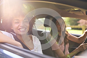 Two Female Friends Or Same Sex Couple In Car On Road Trip Vacation Together