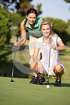 Two Female Golfers On Golf Course