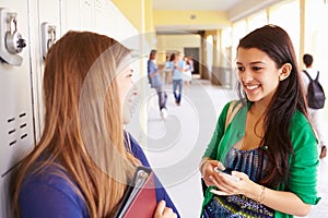 Two Female High School Students Talking By Lockers