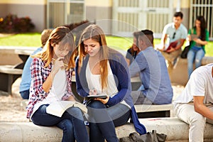 Two Female High School Students Working On Campus