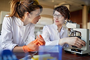 Two female laborant practitioners analyzing samples