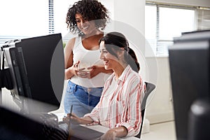 Two Female Retouchers Working At Computer Using Graphics Tablet In Post Production Company