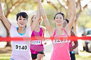 Two Female Runners Finishing Race Together