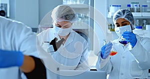 Two female scientists experimenting in laboratory 4k