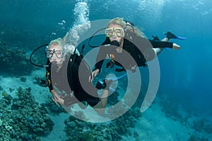 Two female scuba divers dive together