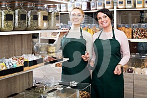 Two female sellers wearing apron