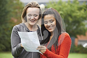 Two Female Students Celebrating Exam Results Together photo