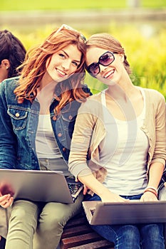 Two female students with laptop computers