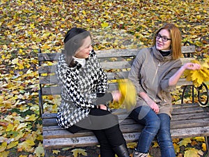 two female students resting in the autumn park