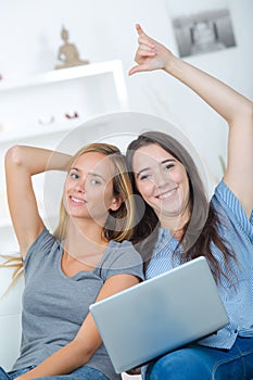 Two female students using laptop