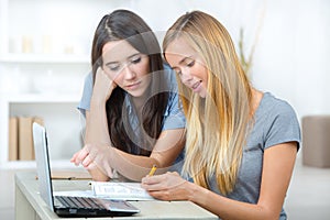 Two female students using laptop