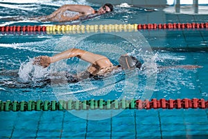 Two female swimmers during a race in the freestyle swim discipline