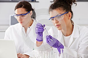 Two Female Technicians Working In Laboratory