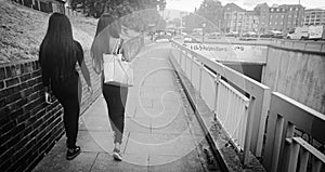 Two female teenages on a footpath