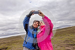 Two female turist friends traveling photographers take a selfie