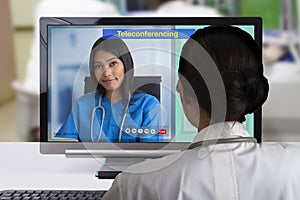 Two females doctor using teleconference technology to discutsion about patient case