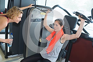 Two females in modern fitness club