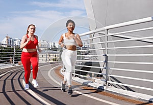 Two females in sportswear with different color running