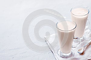 Two fermented drink baked milk ryazhenka kefir glass with immune boosting properties white grey background with copy