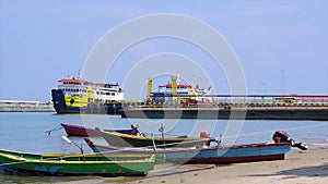 Two ferries and several fishing boats anchored on the beach