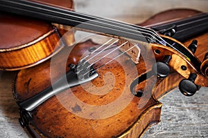 Two fiddles on a wooden background photo