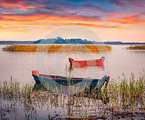 Two fifhing boats on the Svityaz lake. Spectacular sunrise on Shatsky National Park