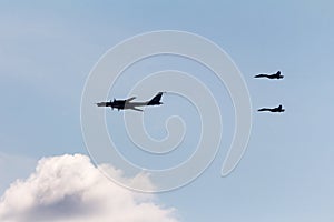 two fighters escort a Tupolev Tu-95mc, russian strategic bombers