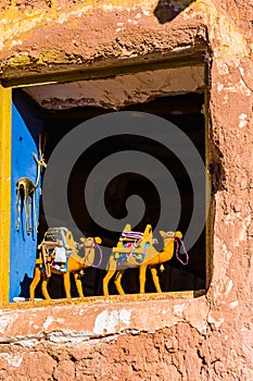 Two figures of camels on the window, Ait-Ben-Haddou, Morocco. Vertical