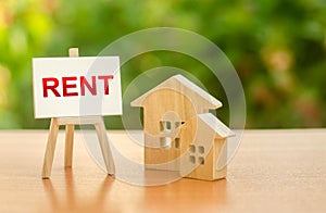 Two figures of houses and an easel with the word rent. The concept of temporary rental housing and real estate. Realtor services