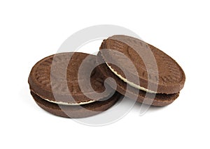 Two filled tea biscuits isolated on white background. Chocolate cookies close-up