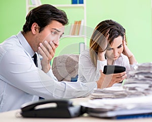 Two financial specialists working in the office