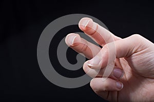 Two fingers of a human hand partly seen in view