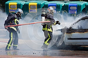 Two firefighters in action