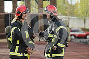 Two firefighters in equipment and helmets on test photo
