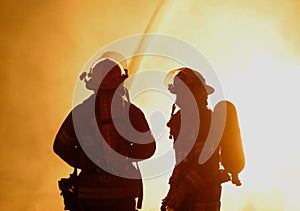 Two firefighters at raging fire