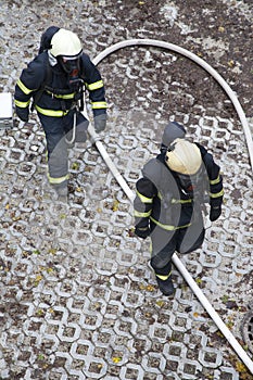 Two firefighters rush to rescue injured people