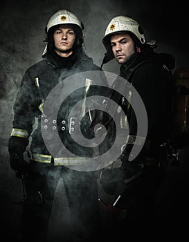 Two firefighters in a smoke