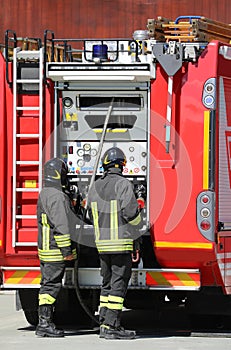 two firemen in action during fire drill