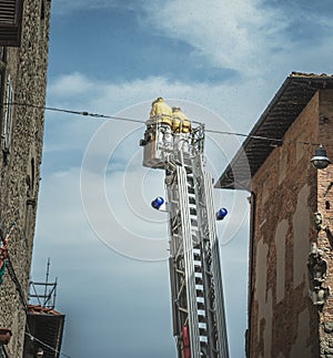 Two firemen on a ladder surrounded by bees in Italy