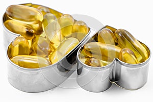 Two Fish Oil in Heart shape boxes isolated