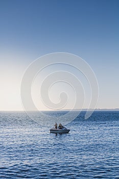 Two fishermen fishing in the Oresund strait, Denmark