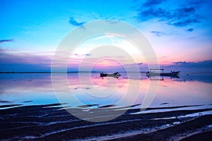 two fishing boats with background sunrise