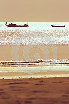 Two fishing boats backlit during sunset