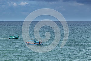 Two fishing boats crossing each off the waters of the Gulf of Thailand
